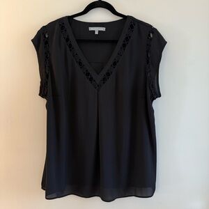 Black blouse with cut out details. Size 2X. Looks great untucked or tucked.